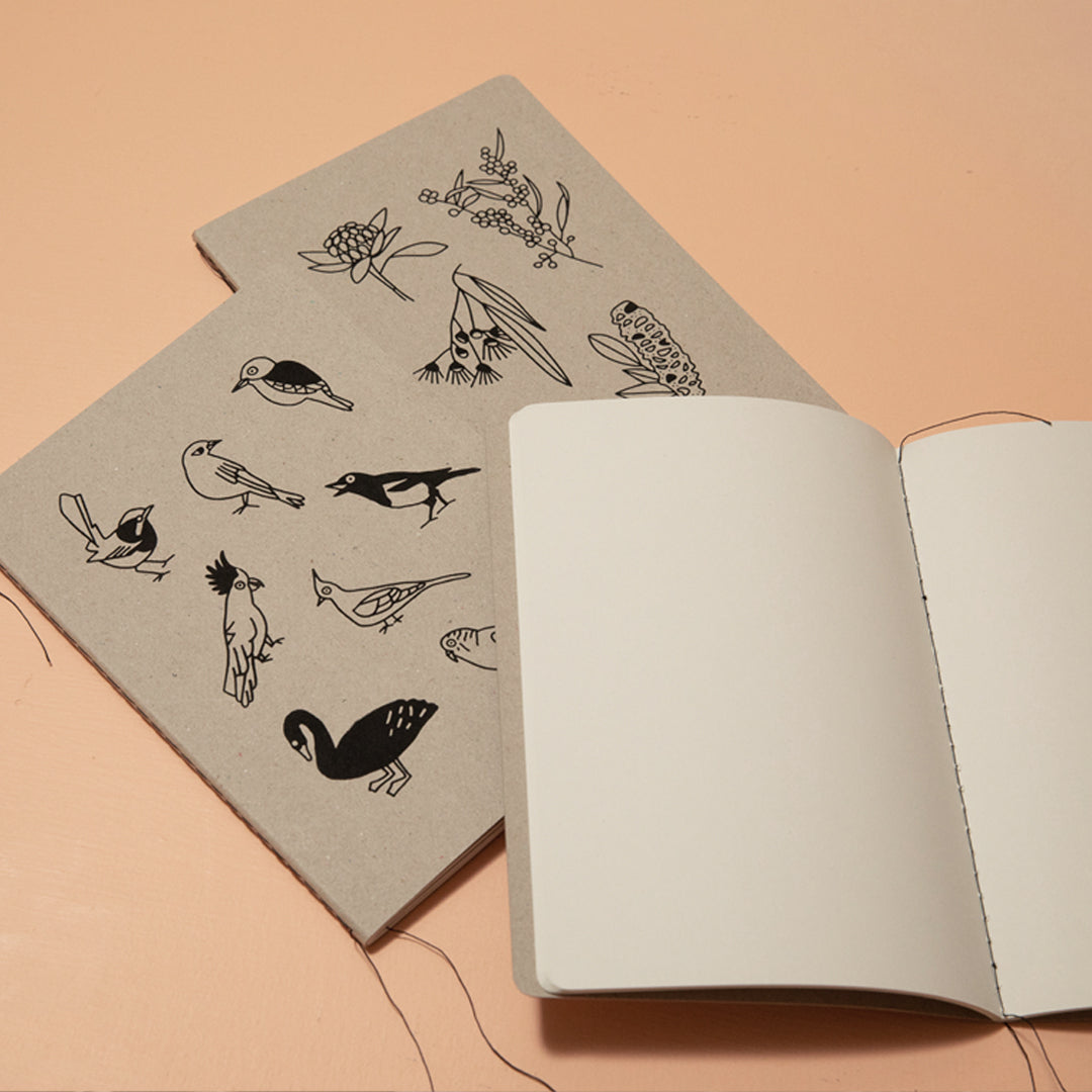 Notebook with bird illustrations on a beige background