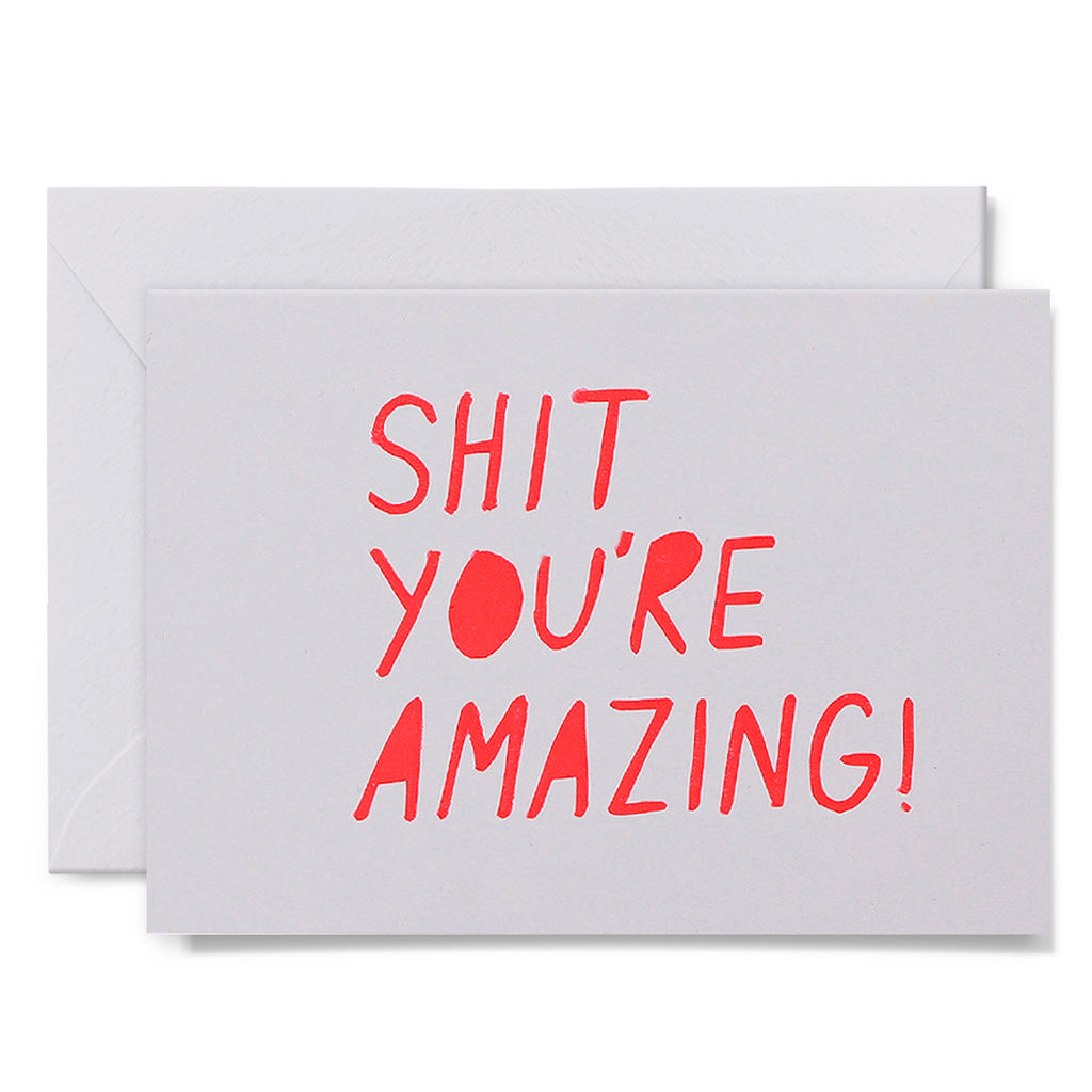 White card with red text 'SHIT YOU'RE AMAZING